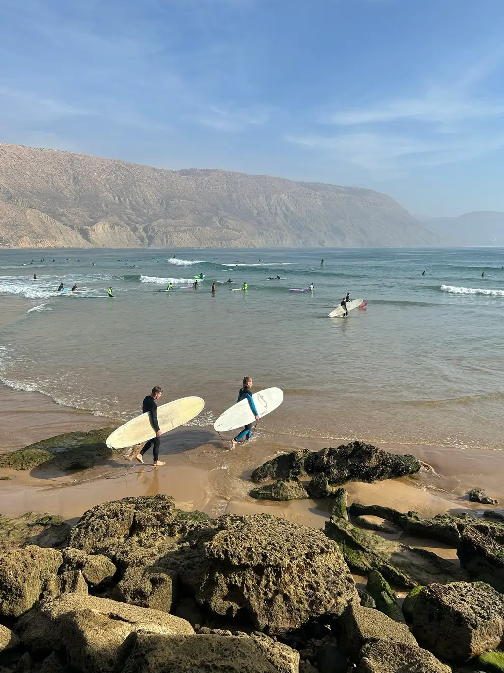 Surfers walking out at Taghazout beach